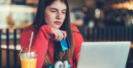 Teenage girl making online payments with credit card ++++ Note for the inspector: Credit card is fake ++++