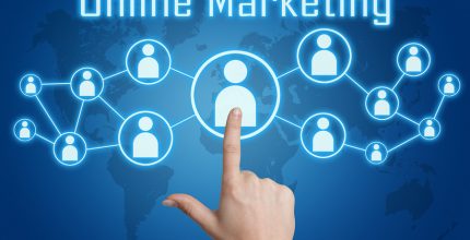 woman hand pressing online marketing icon on blue background with world map
